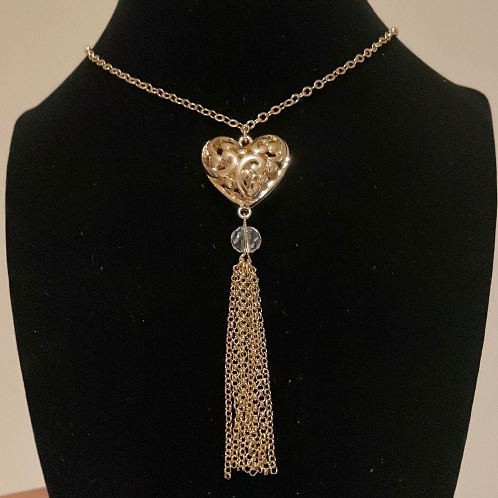 17 inches long golden color heart and tassels necklace. accents on the site